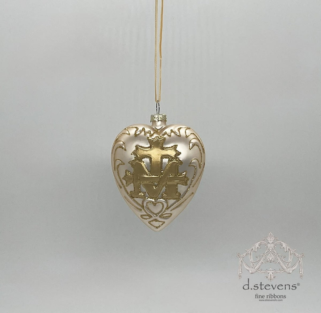 Platinum glass heart-shaped ornament featuring a gold cross and crest design.