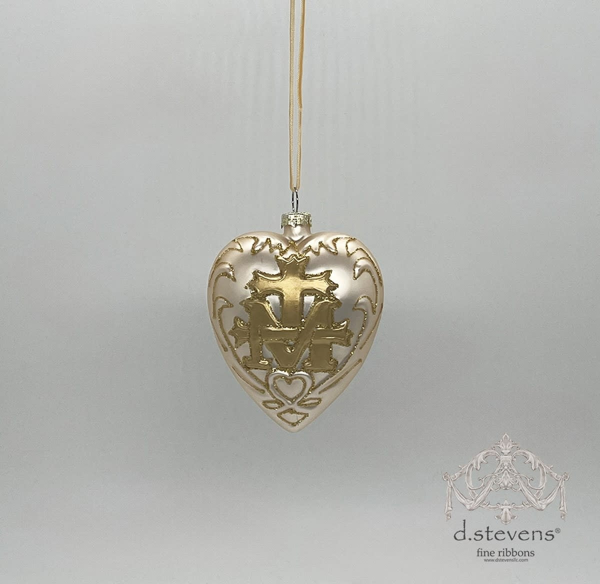 Platinum glass heart-shaped ornament featuring a gold cross and crest design.