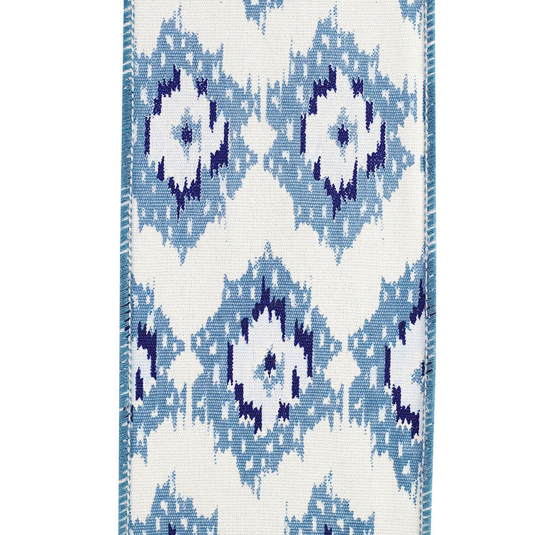 4-inch wide white and blue ikat patterned canvas ribbon with a wired edge.