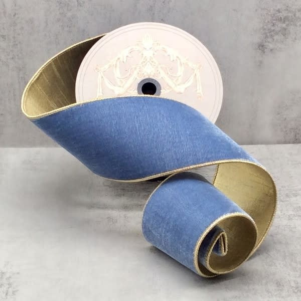 A spool of 4-inch wide dusty blue velvet ribbon with a gold metallic backing and finished edges.
