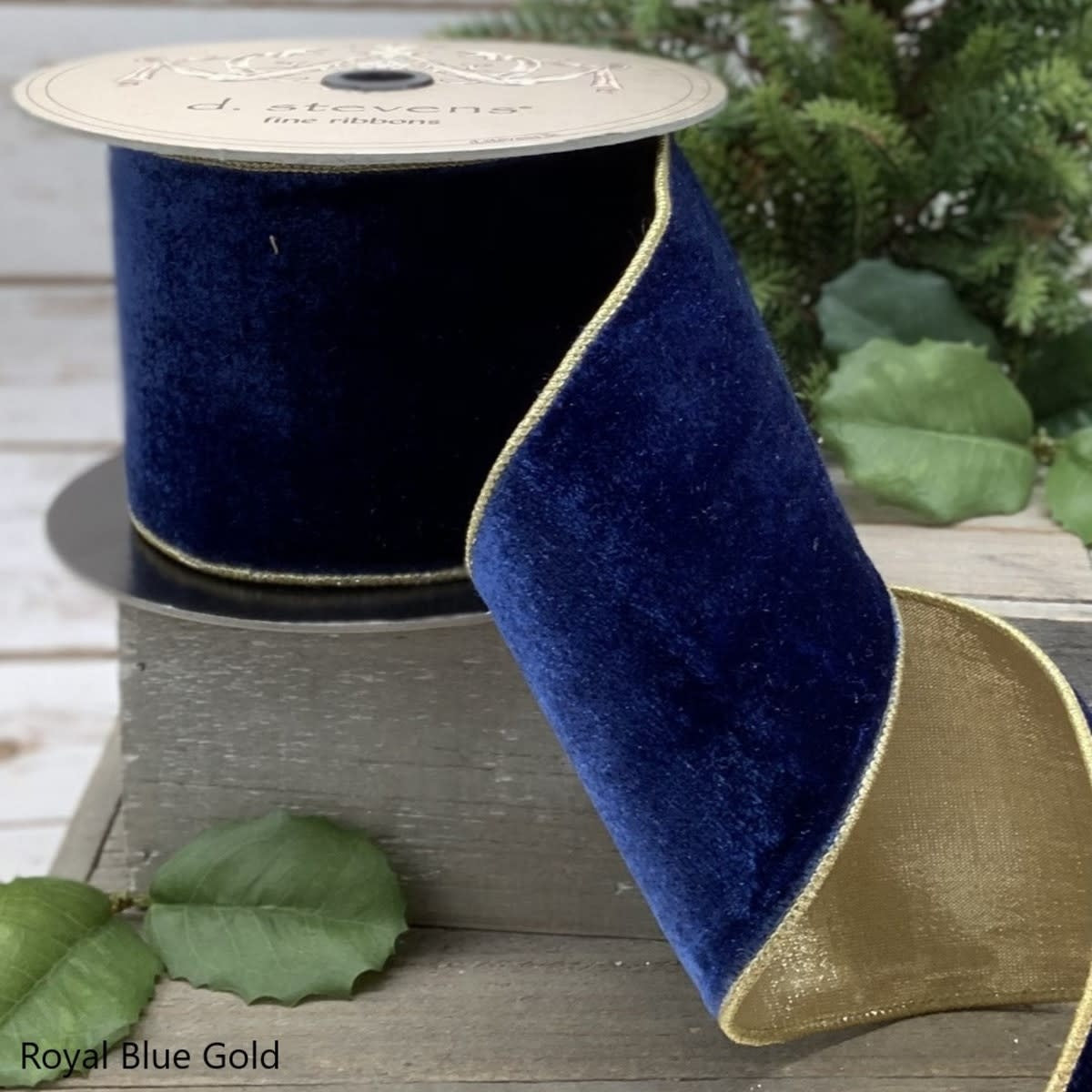 4-inch wide royal blue velvet ribbon with gold metallic edges on a spool.