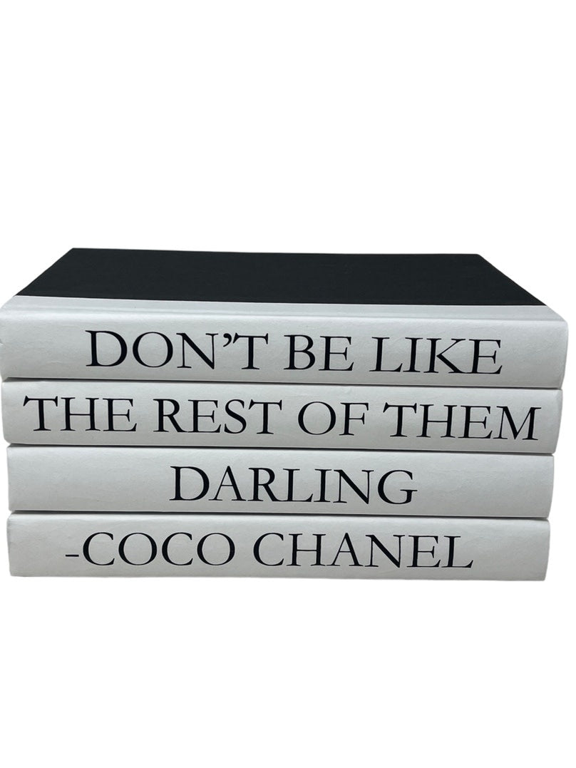 Set of four black hardcover books featuring the quote 'Don't be like Coco Chanel' on their covers.