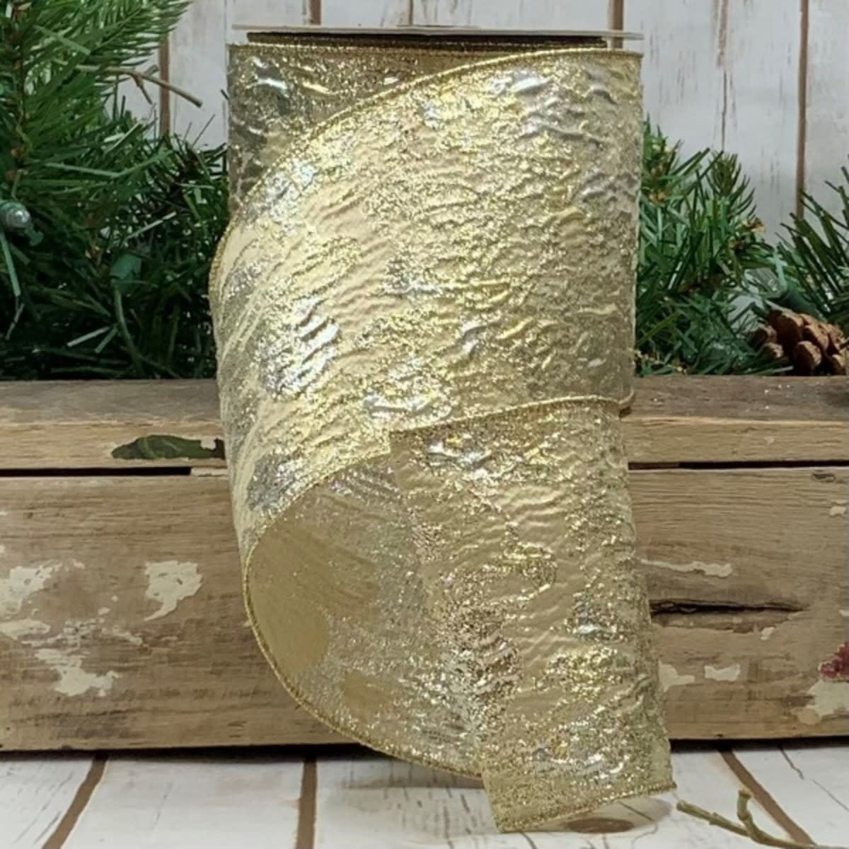 Ten yards of cream-colored ribbon with a gold metallic jacquard pattern.