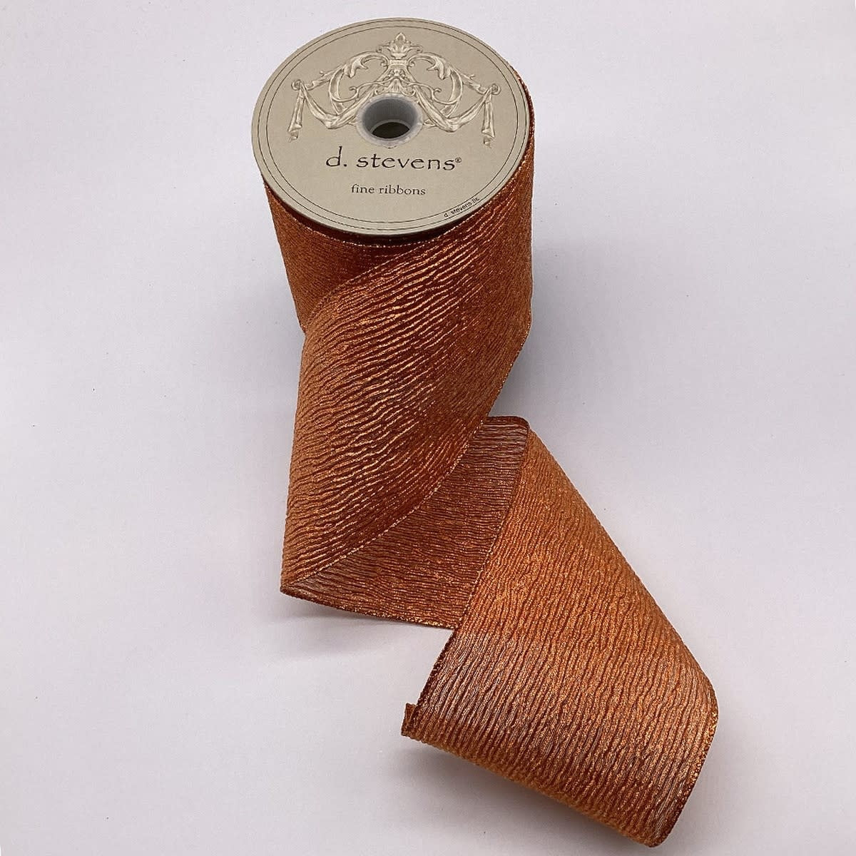 4-inch wide copper lame crinkle mesh fabric roll with a shimmering metallic finish.
