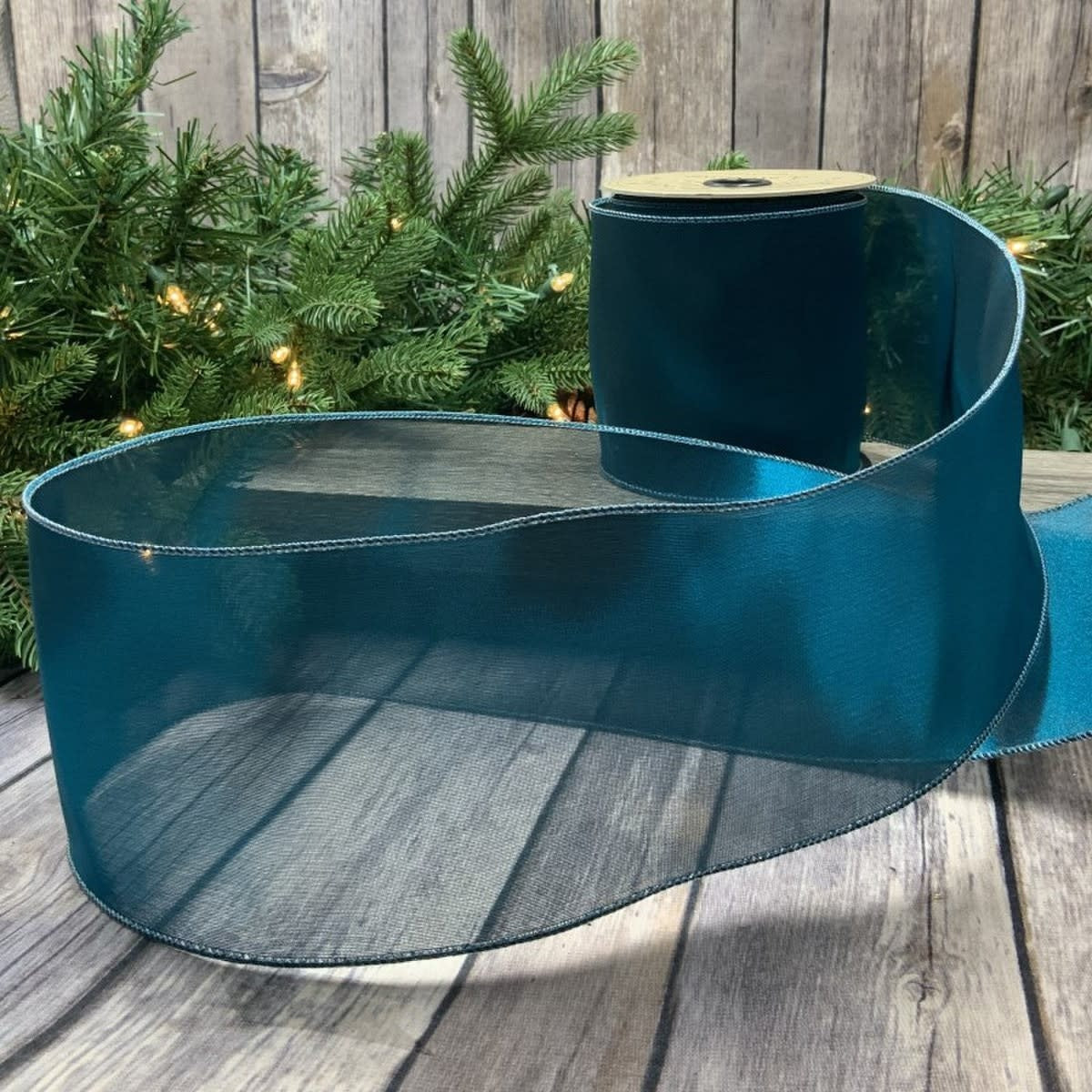 4-inch wide by 10-yard roll of metallic tissue silk in peacock blue with shimmering iridescent finish.
