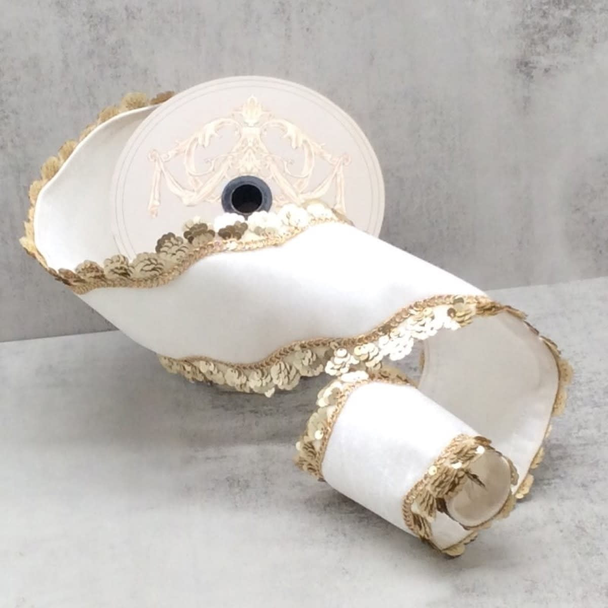 Gold velvet ribbon with sequin wave side trim on white background