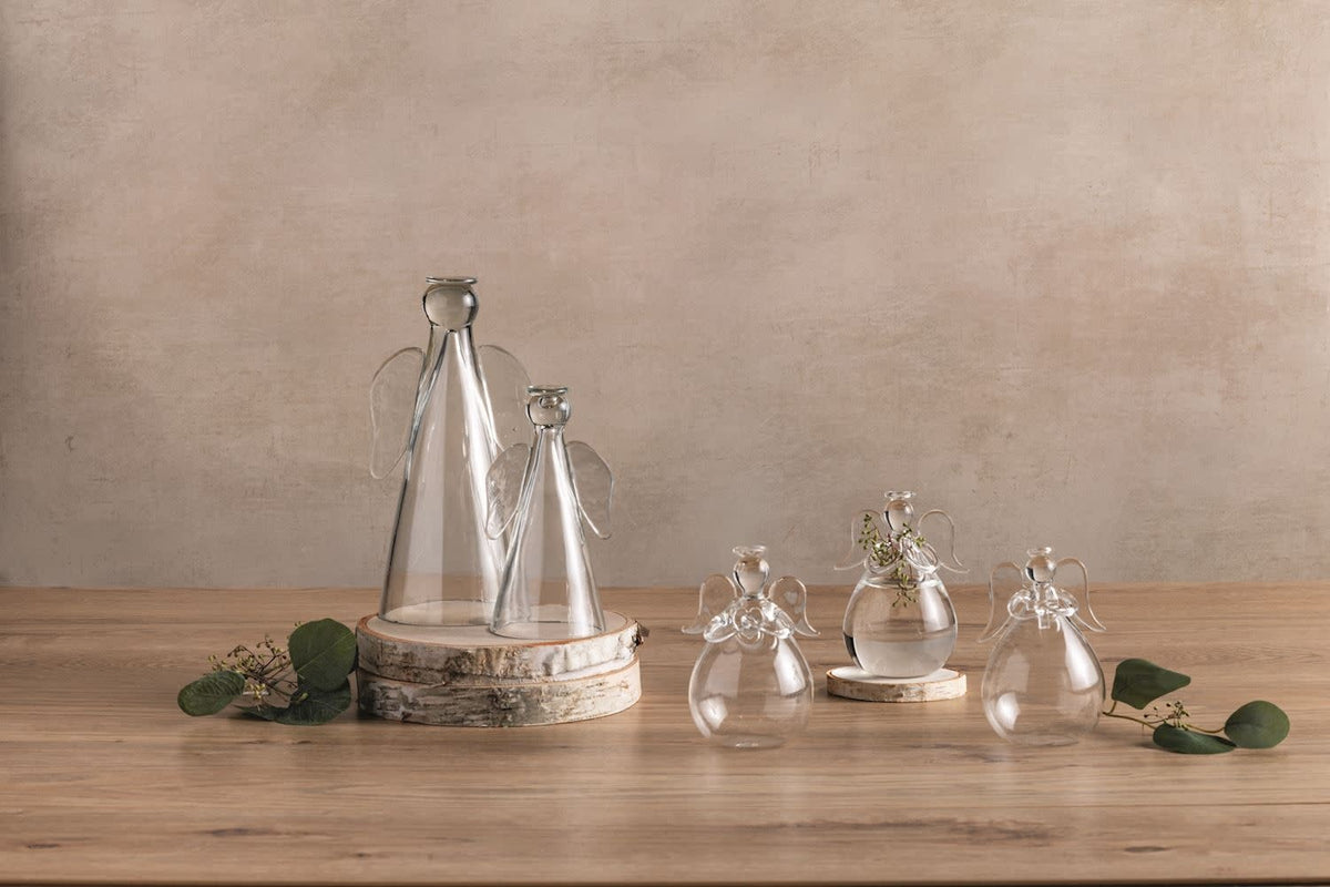 Glass angel sitter figurine with hollow base holding a flameless tea light.