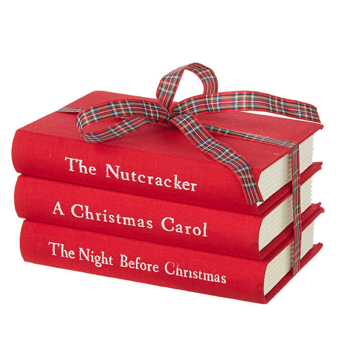 Red stacked paper Christmas books with a whimsical holiday bookshelf silhouette.