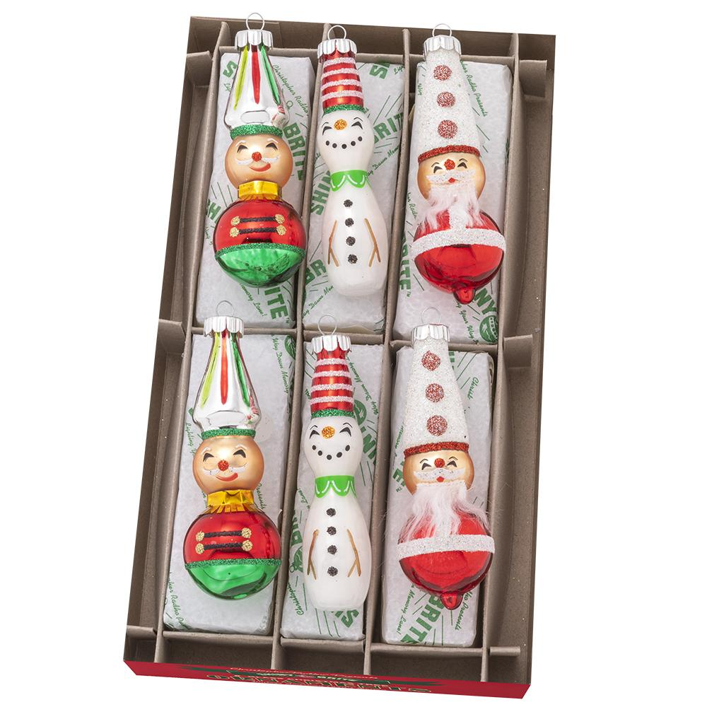 Six glass holiday figures including snowmen, nutcrackers, and Santas in festive colors.