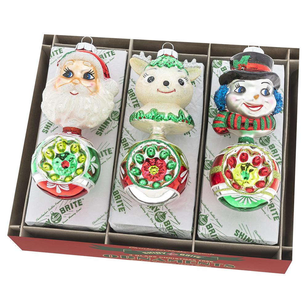 Three Christopher Radko Holiday Splendor figure ornaments in red, green, and gold with festive patterns.