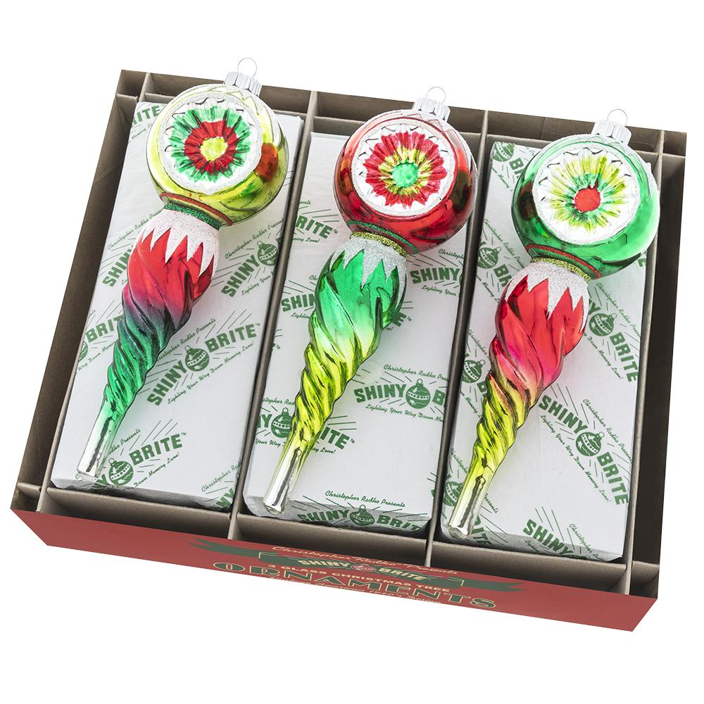 Boxed Holiday Splendor icicle ornaments with green glass reflectors and red round decorations.