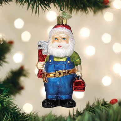 Handyman Santa figurine in red suit holding a wrench next to an open blue toolbox.