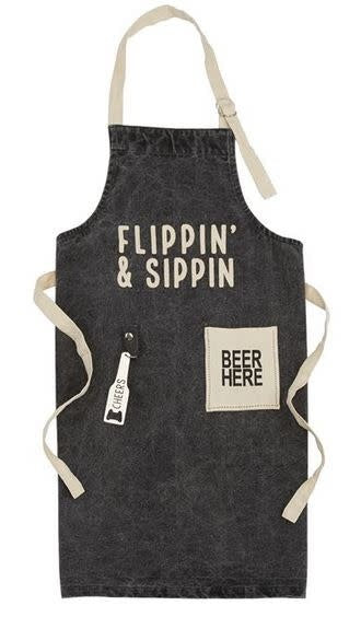Washed canvas apron with printed sentiment, beer pocket, metal bottle opener tab, and adjustable neckline.