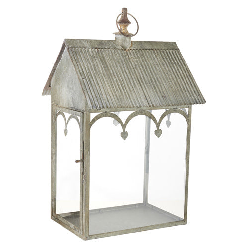 Twenty-four inch antiqued metal lantern with acrylic panels in a warm finish.