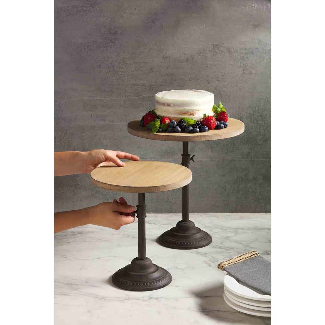 Adjustable pine wood server with cast iron pedestal on a neutral background.