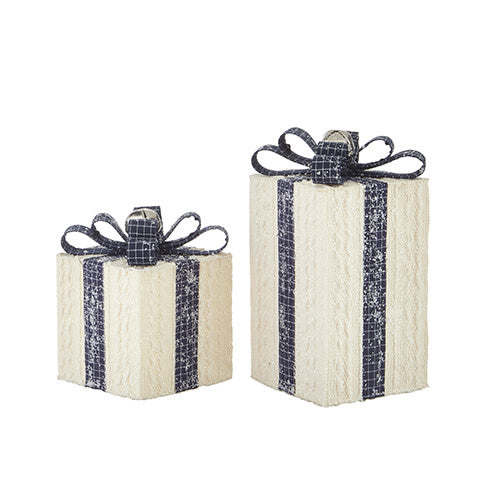 Foam gift ornament with white plaid fabric, navy ribbon bow with silver glitter underside, and a silver bell.
