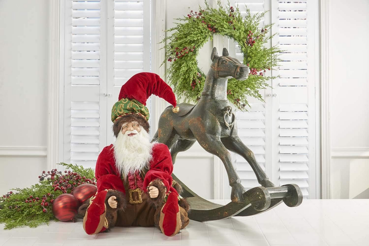 43.5 inch black painted wooden rocking horse with a Santa figure and holiday wreath.