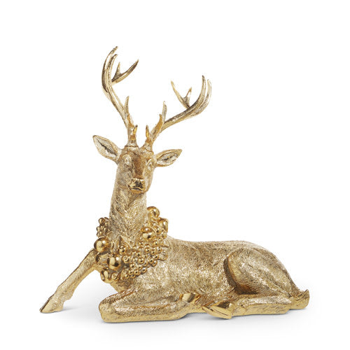 Gold resin deer figurine with tall antlers wearing a wreath around its neck.