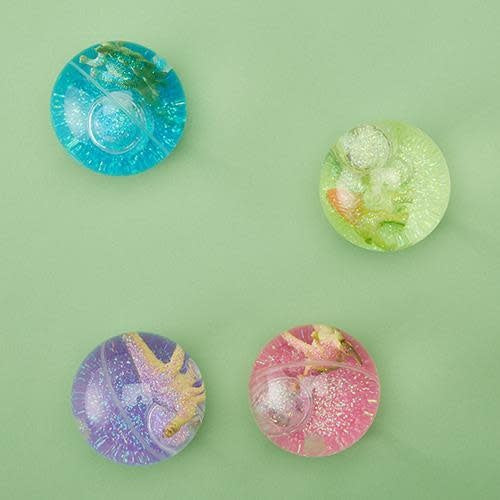 Dinosaur bouncing ball with rainbow LED lights inside a glitter-filled glass jar.