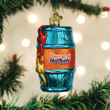Wooden barrel ornament with multiple monkey figures climbing on its sides.