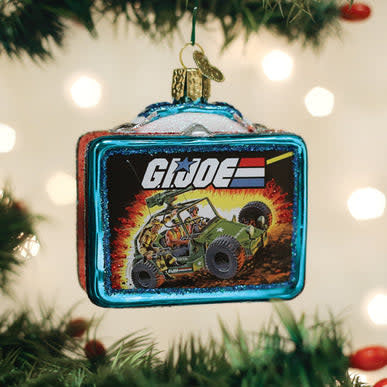 Red G.I. Joe lunchbox ornament with white handle hanging on a Christmas tree.