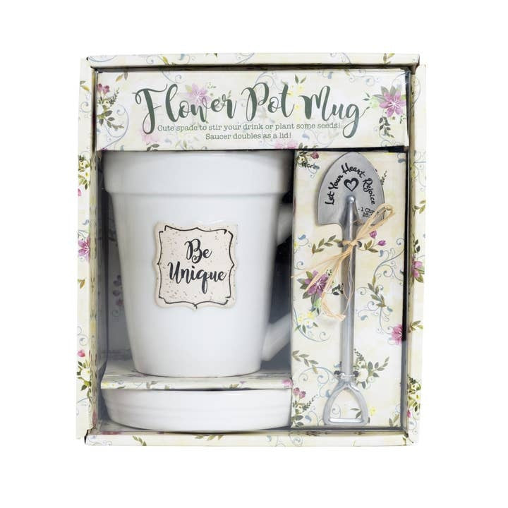 White ceramic mug shaped like a flower pot with coordinating saucer lid and stainless steel garden spade spoon.