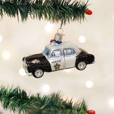 Small blue police car ornament with white roof lights and silver grille.