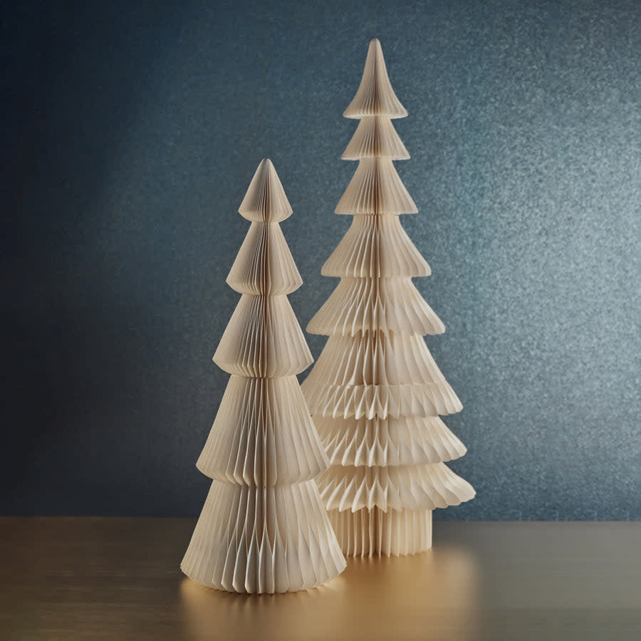 Ivory accordion paper Davos tree with conifer branches standing upright on a surface.