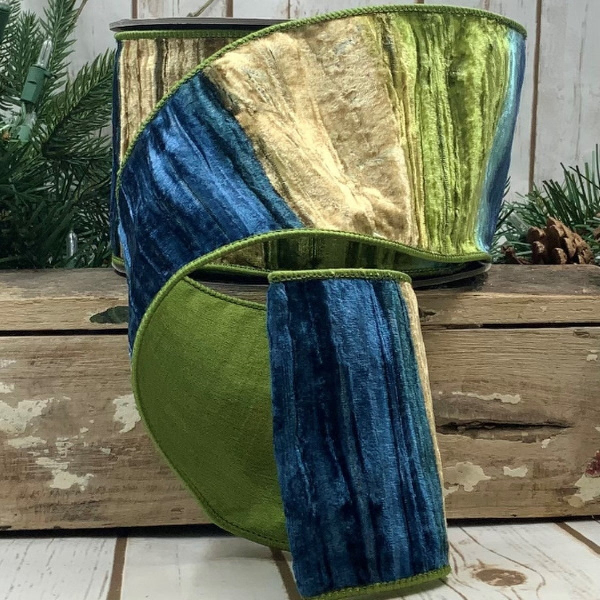4 inch wide velvet ombre ribbon in green, blue, and mocha colors on a wooden surface.