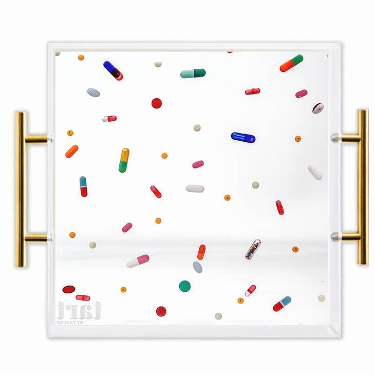 Square acrylic tray with gold handles featuring a classic pill-shaped handle pattern.
