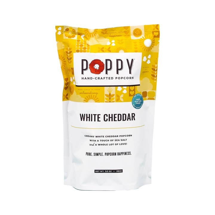 Open bag of white cheddar popcorn with visible dill flakes