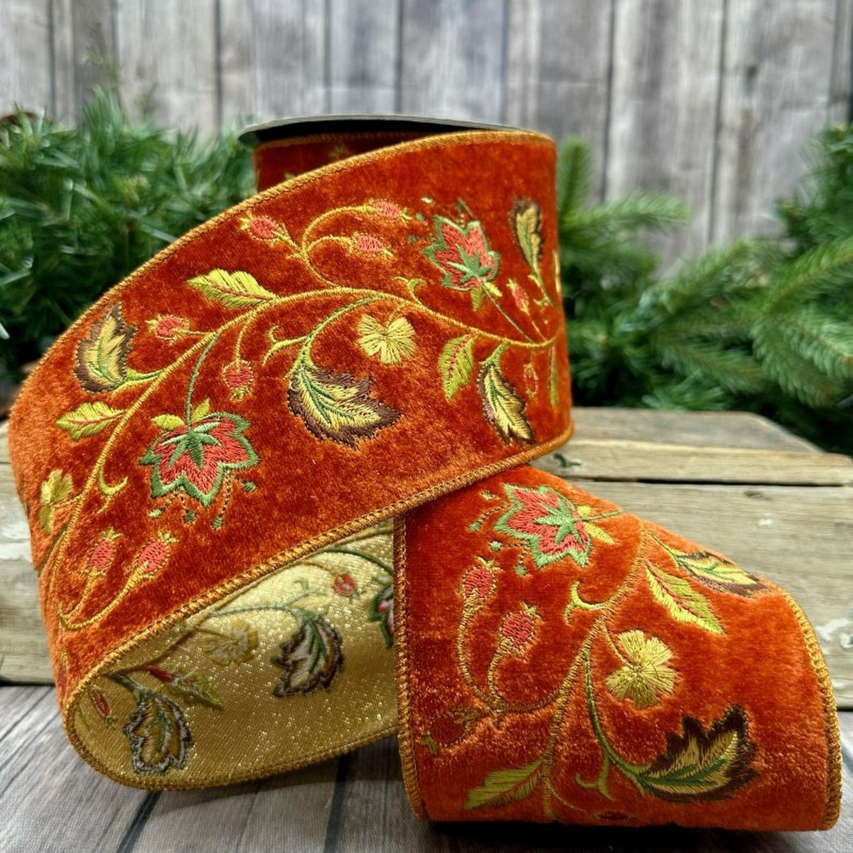 4-inch terra cotta faux velvet ribbon with embroidered autumn leaves and vines on a spool.