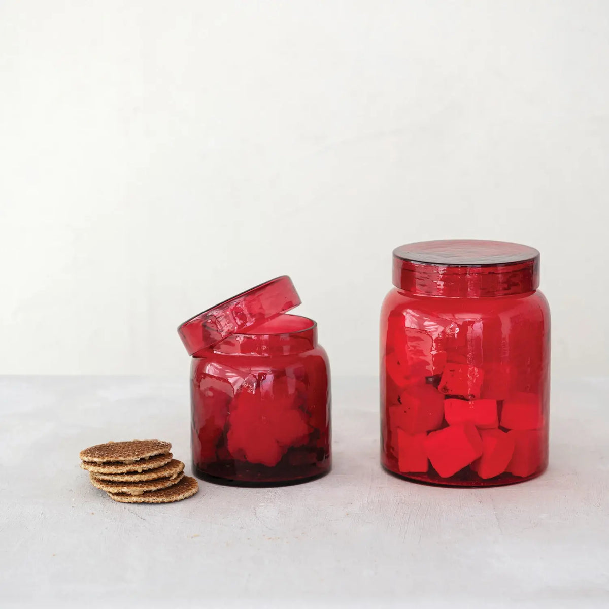 Red glass storage jar with cylindrical shape