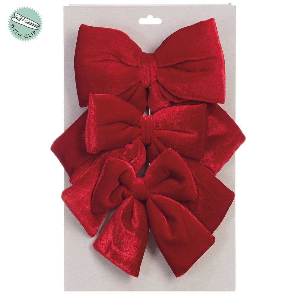Red velvet bow clip set with metal hardware, measuring five to seven inches.