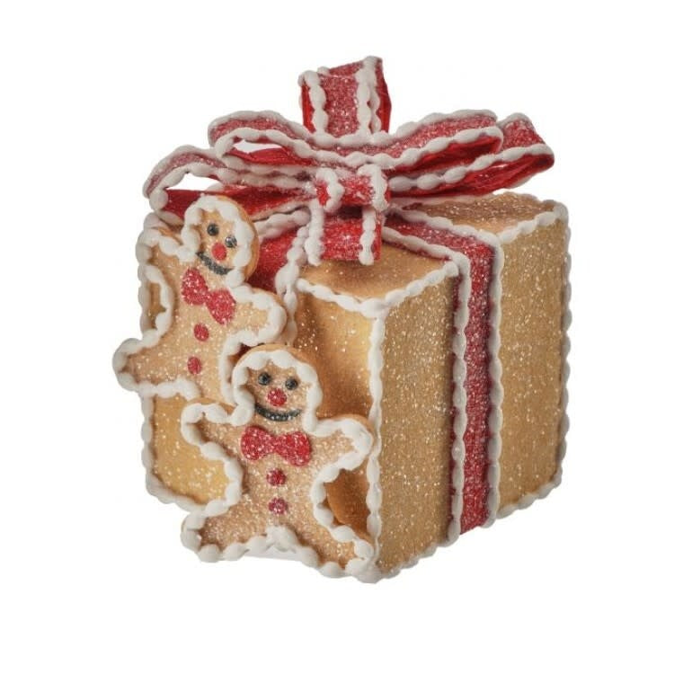 Five-inch gingerbread house ornament in brown with white roof tiles inside a gift box