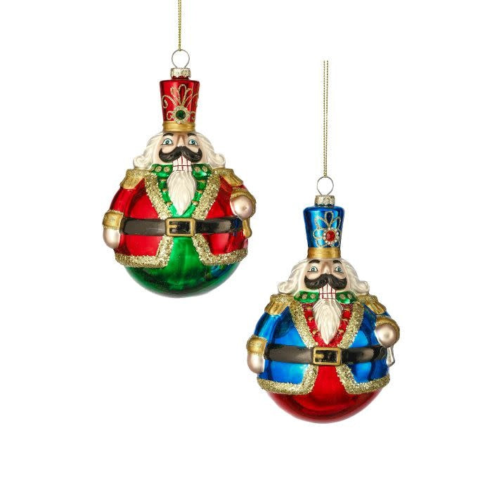 Glossy glass ball ornament featuring a colorful toy soldier silhouette with festive holiday artwork.