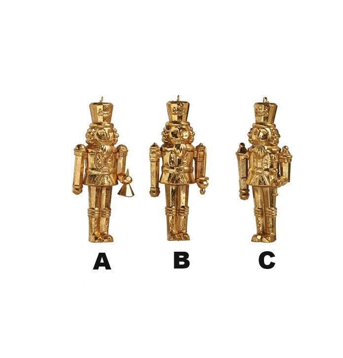 Gold plastic nutcracker ornament with a classic soldier silhouette hanging on a Christmas tree.