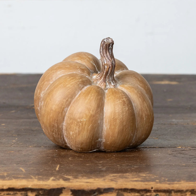 Brown resin pumpkin with textured surface and warm tones