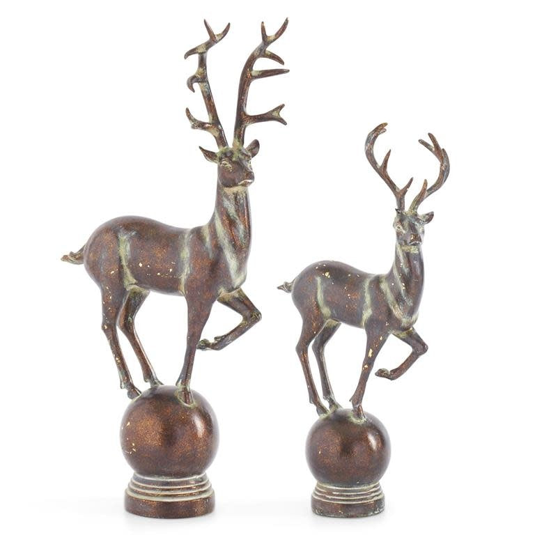 Whitewashed brown resin deer figurine standing on a spherical base.