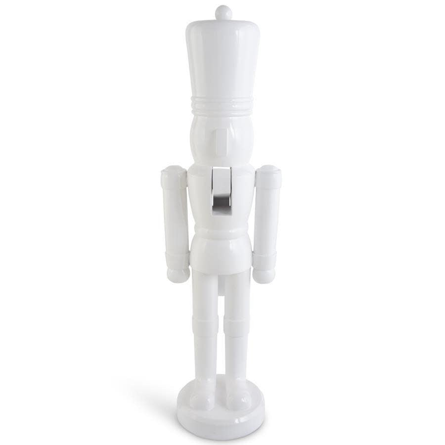 White resin nutcracker soldier statue with detailed uniform standing upright.