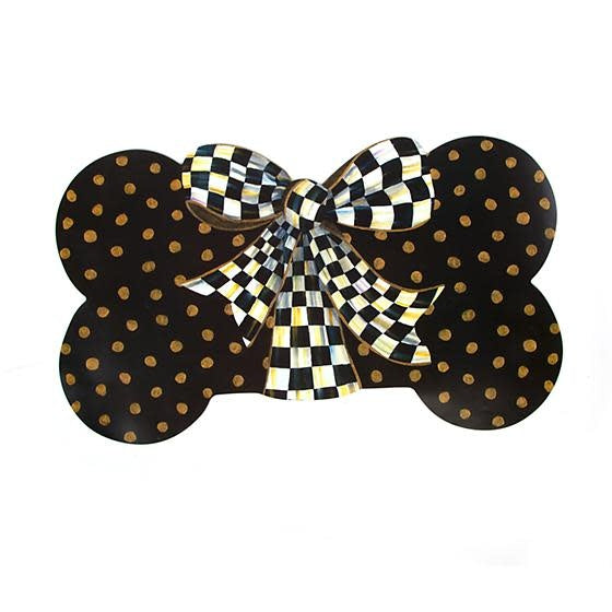 Bone-shaped black polypropylene placemat with gold dots and a Courtly Check ribbon bow.