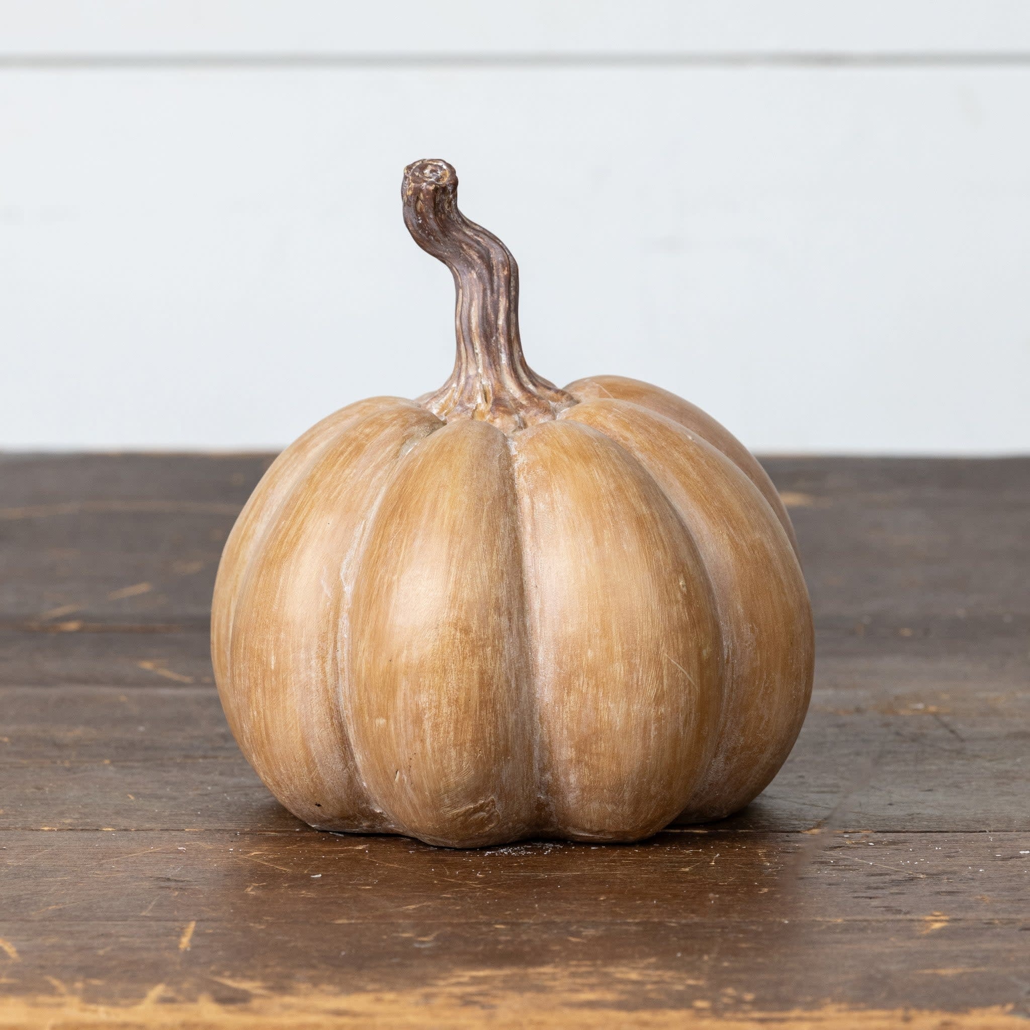Brown resin pumpkin with textured surface and warm tones