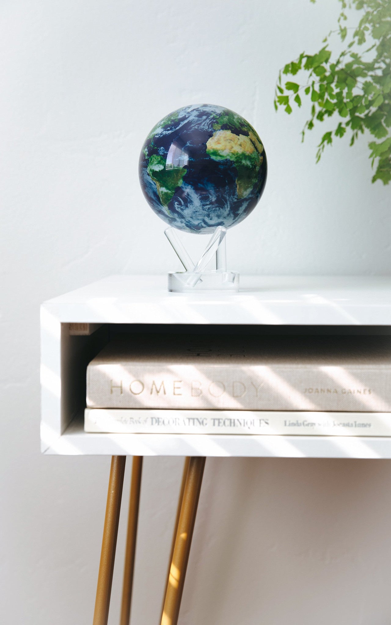 6-inch rotating Earth globe with cloud patterns on a clear acrylic base.