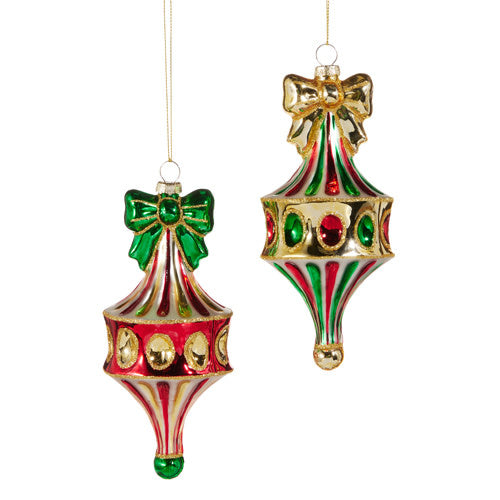 Six-inch red glass fairground finial ornament with green accents on a tree branch.