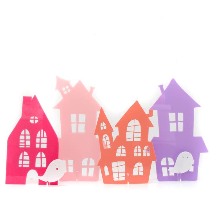 Acrylic haunted house toy with spooky scene, approximately eight inches tall.