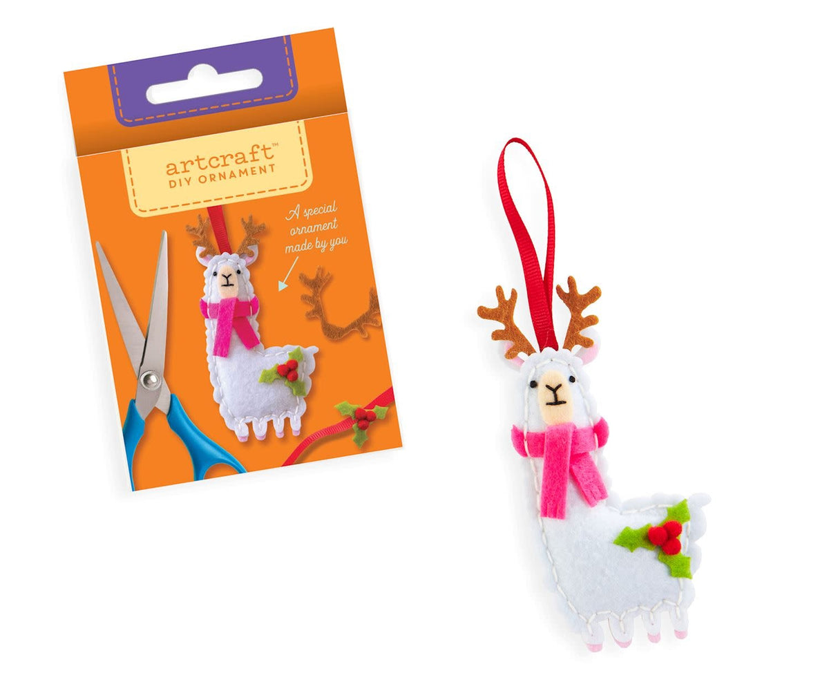 DIY Felt Ornament Kit with red felt pieces, batting, thread, needles, pom poms, and ribbon.