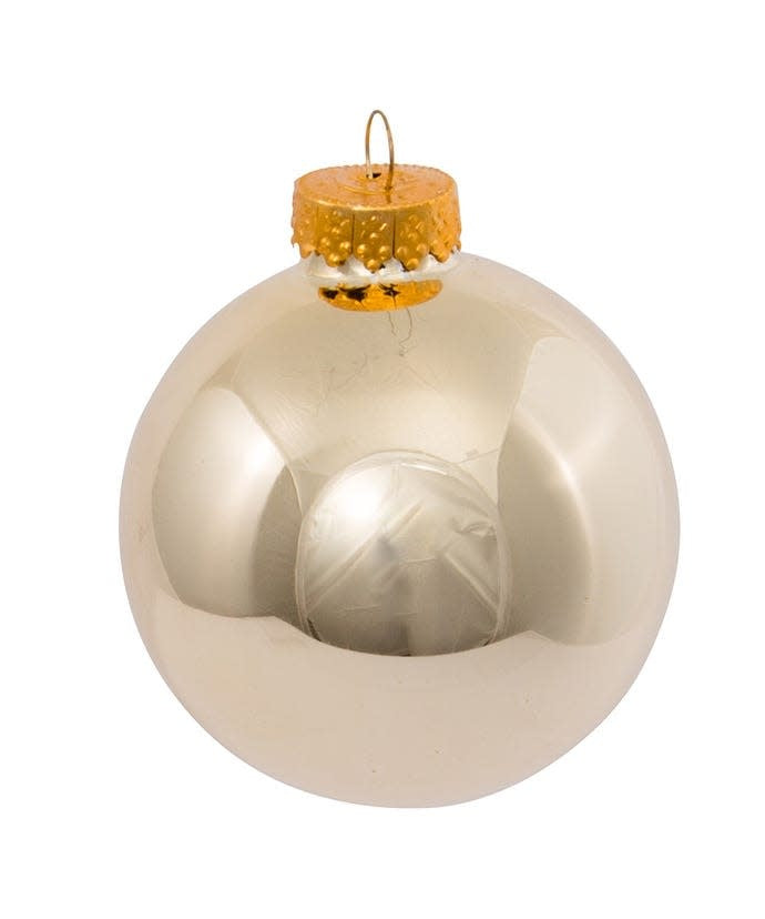 Set of six shiny gold glass ball ornaments with a classic spherical shape.