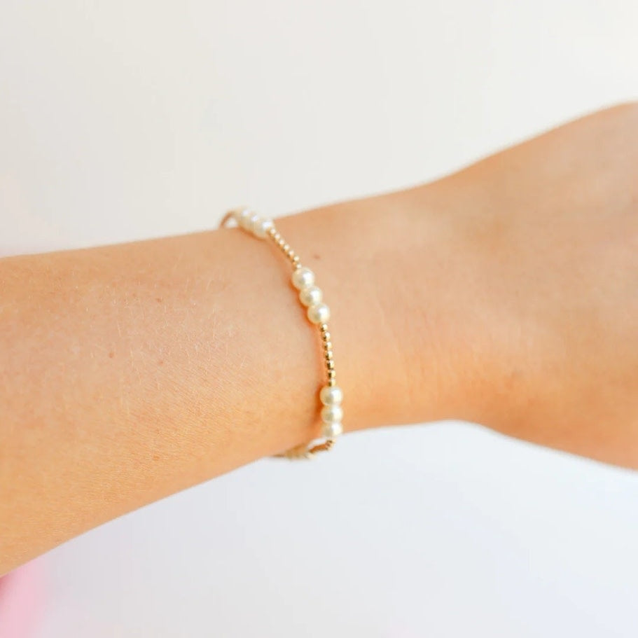 Gold-colored elastic pearl bracelet with a 6.75-inch length.