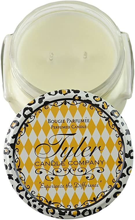 A white ceramic jar containing a Tyler Candle with visible wax surface.