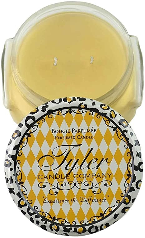 A large black jar candle with a white wick inside.